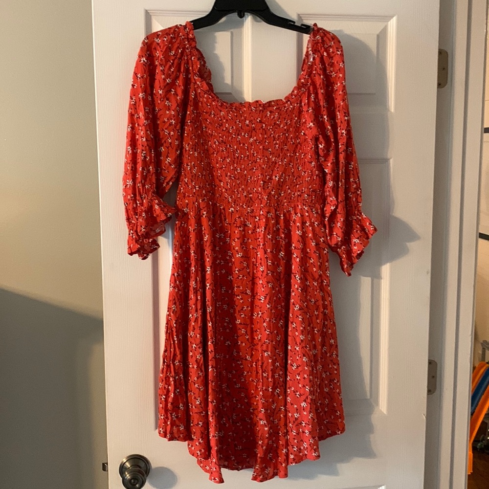 Red floral dress. Size small. Runs a little big due to smocking on the front.